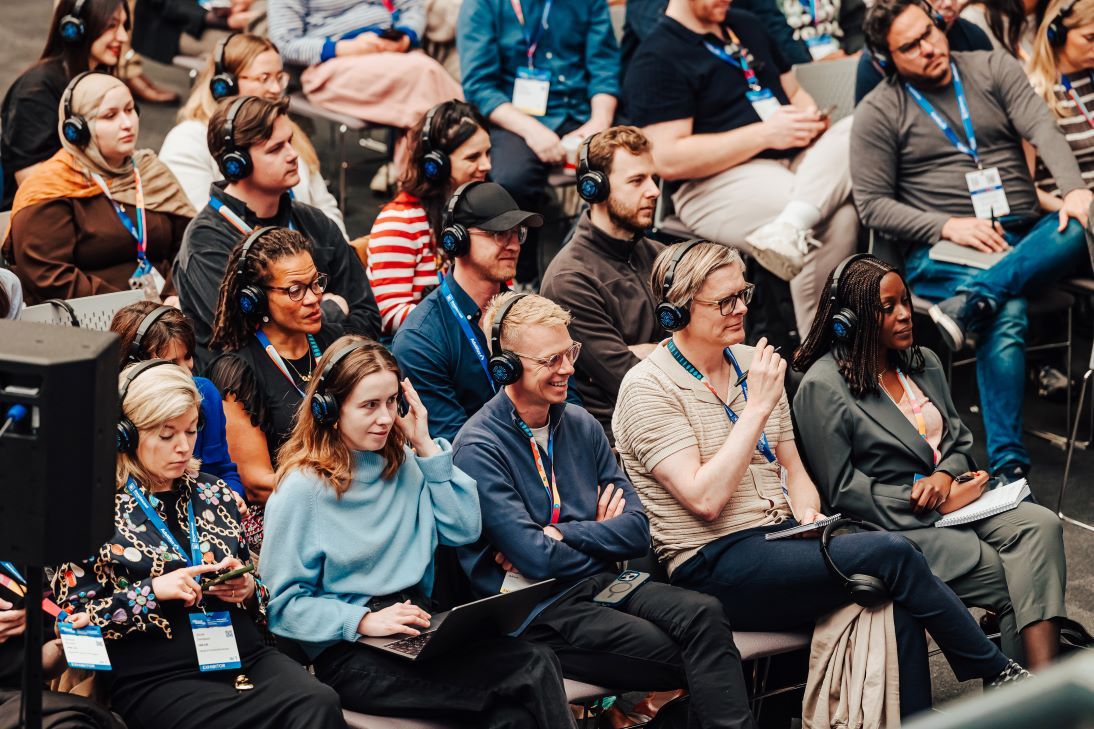 Podcast Creators with headphones on listening to a session.