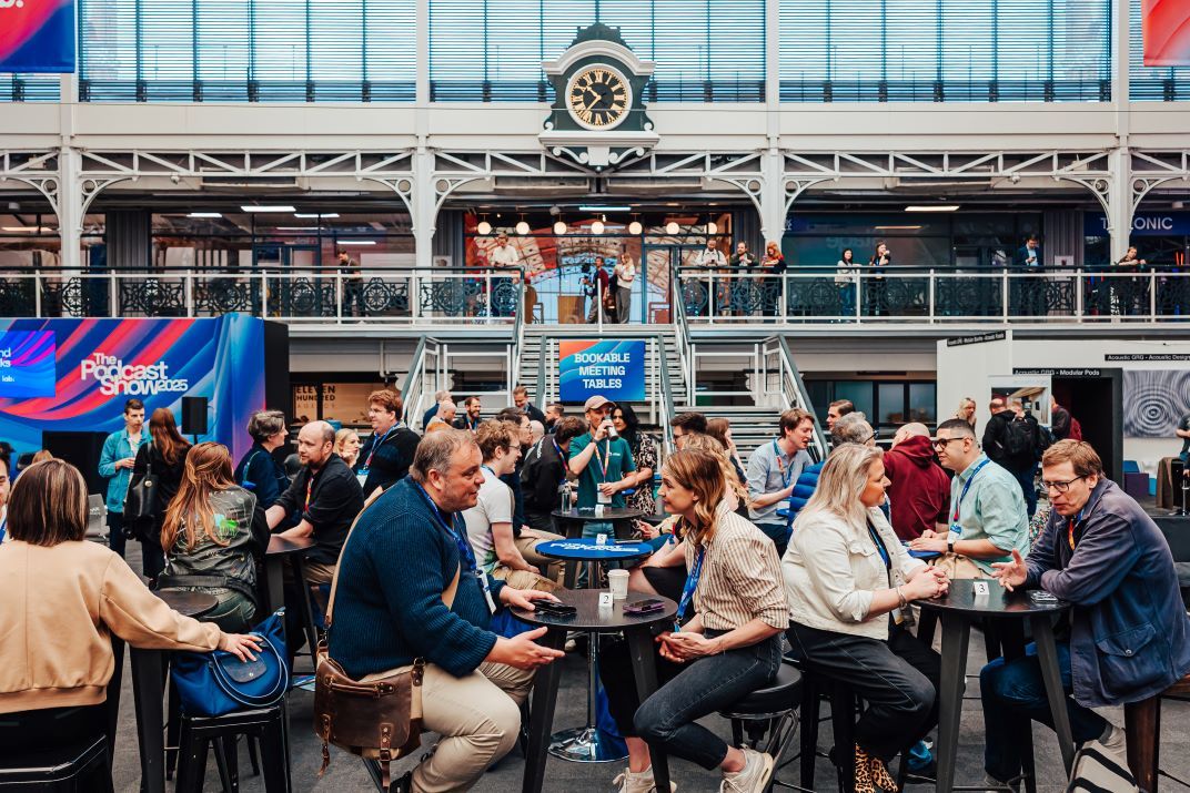 Delegates sitting at the networking meeting tables on the show floow.
