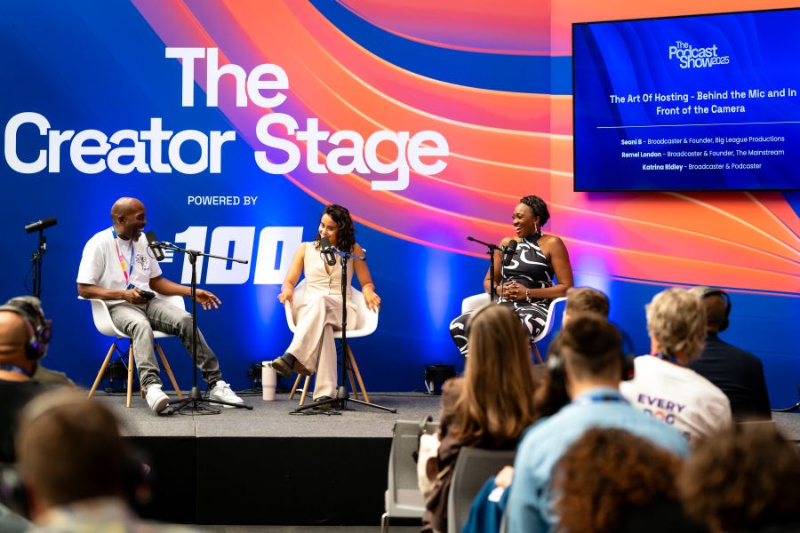    The Creator Stage Panellists laughing on stage.