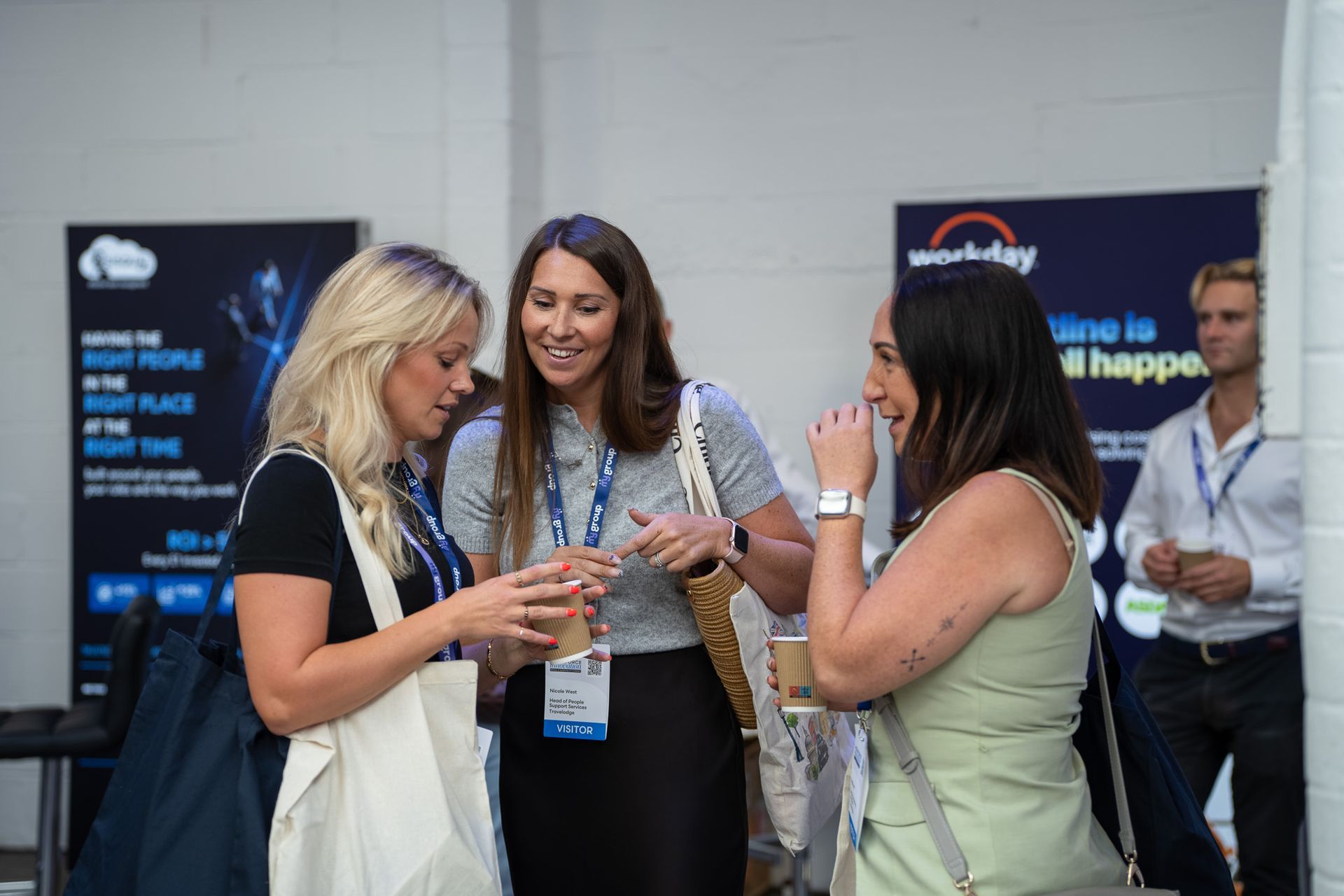 Visitors talking over coffee at WIE 2026