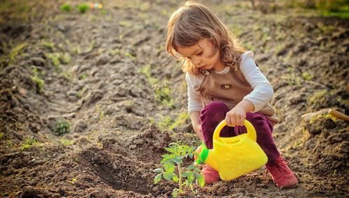 Baby watering plants