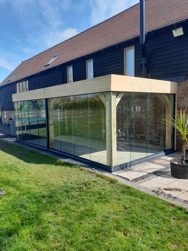 Custom built wooden Veranda with sliding glass doors and living roof system