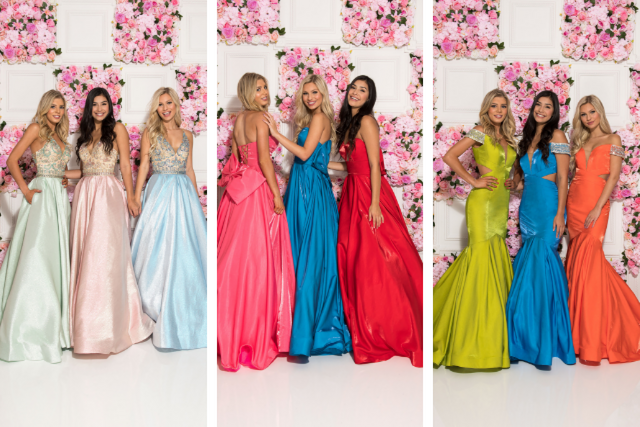 Girls wearing ball gowns in front of a wall with pink flowers