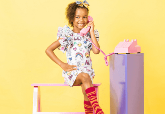Little girl talking on a pink telephone