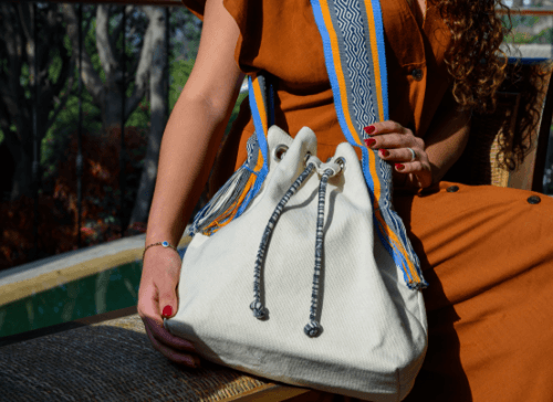 A woman holding a colourful bag 