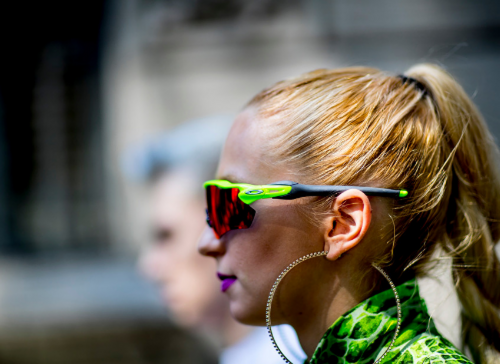 Woman with a ponytail and green sunglasses
