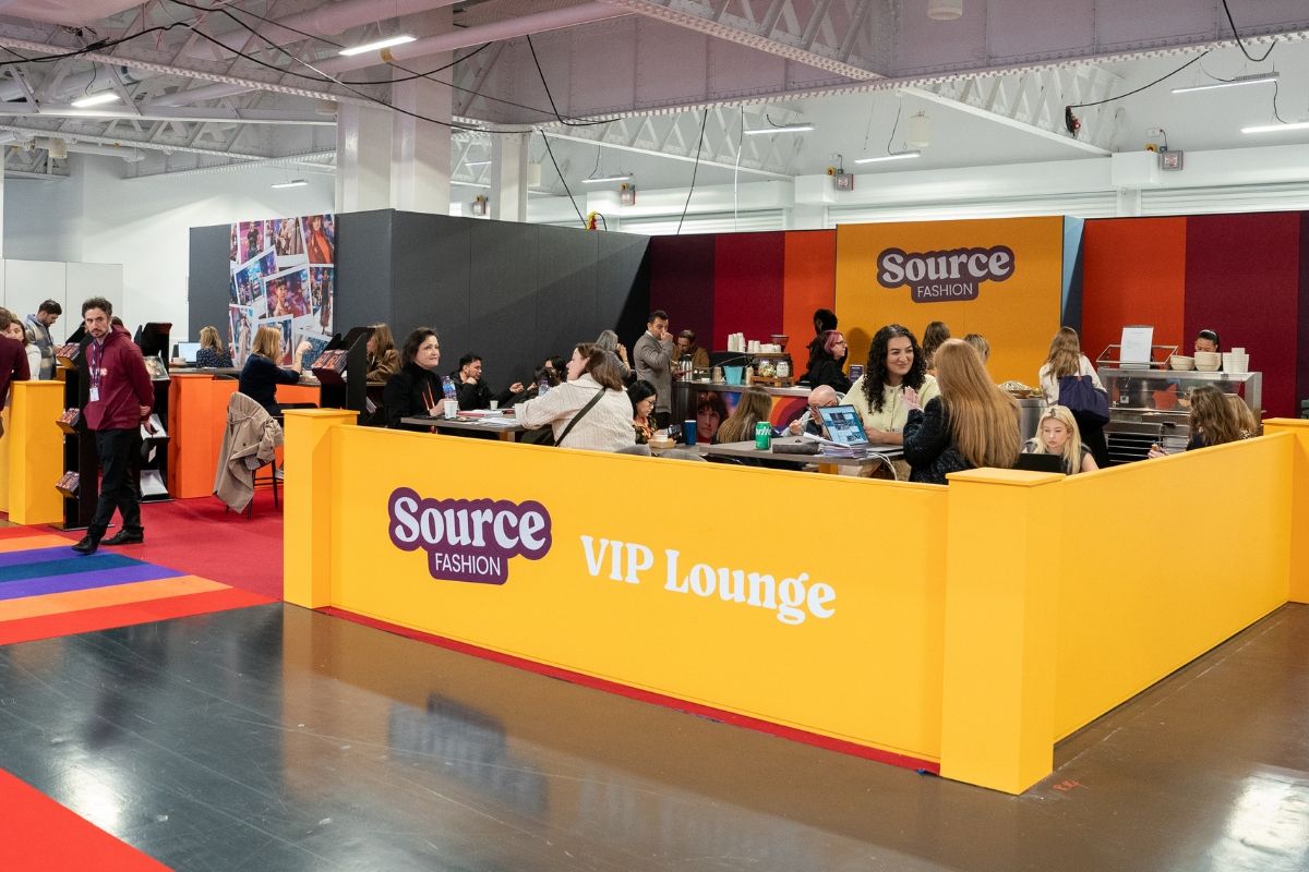 A group of people sitting at a yellow reception deskAI-generated content may be incorrect.