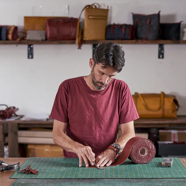 Man making bag from a hose