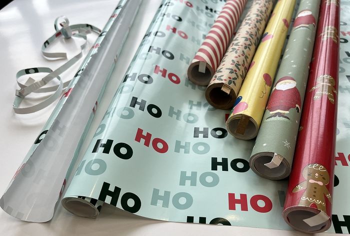 Gift wrapping paper with tear strip tear off process