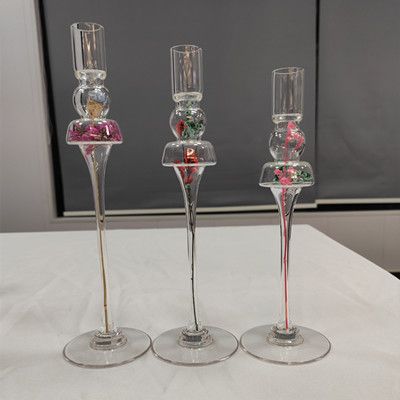 Glass candle holder with flower inside