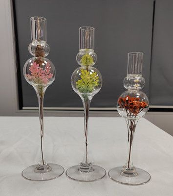 Glass candle holder with flower inside