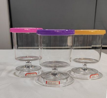 Glass candle holder with color decoration