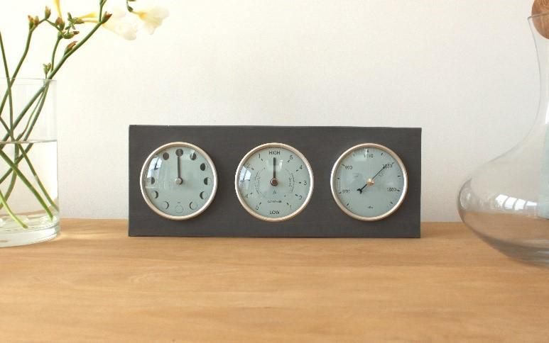 three dial clock on table