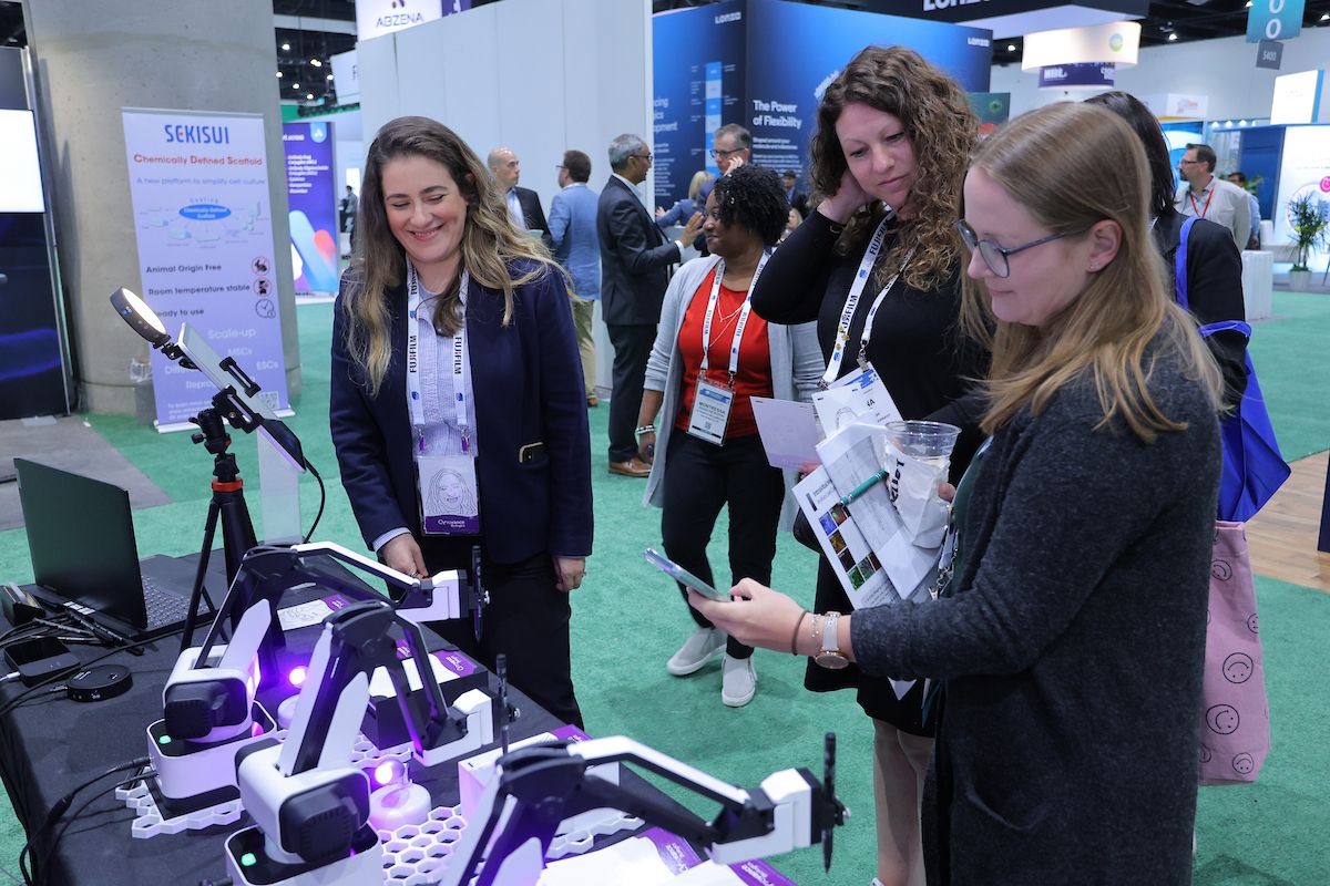 people looking at product in booth