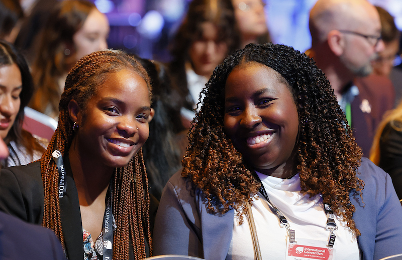 2 women sitting in an audience