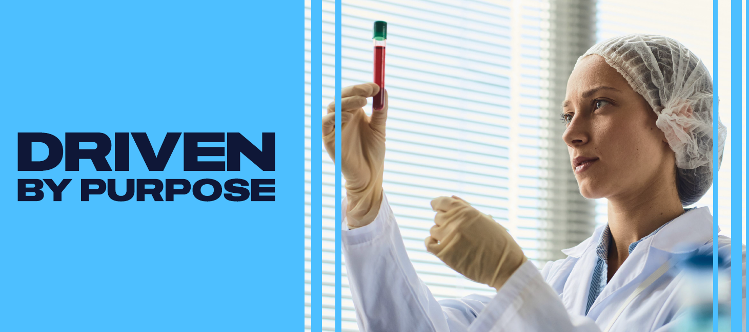 woman in a lab holding up a test tube