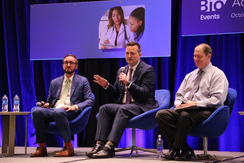 3 men on stage speaking at the BIO Patient and Health Advocacy Summit 2023