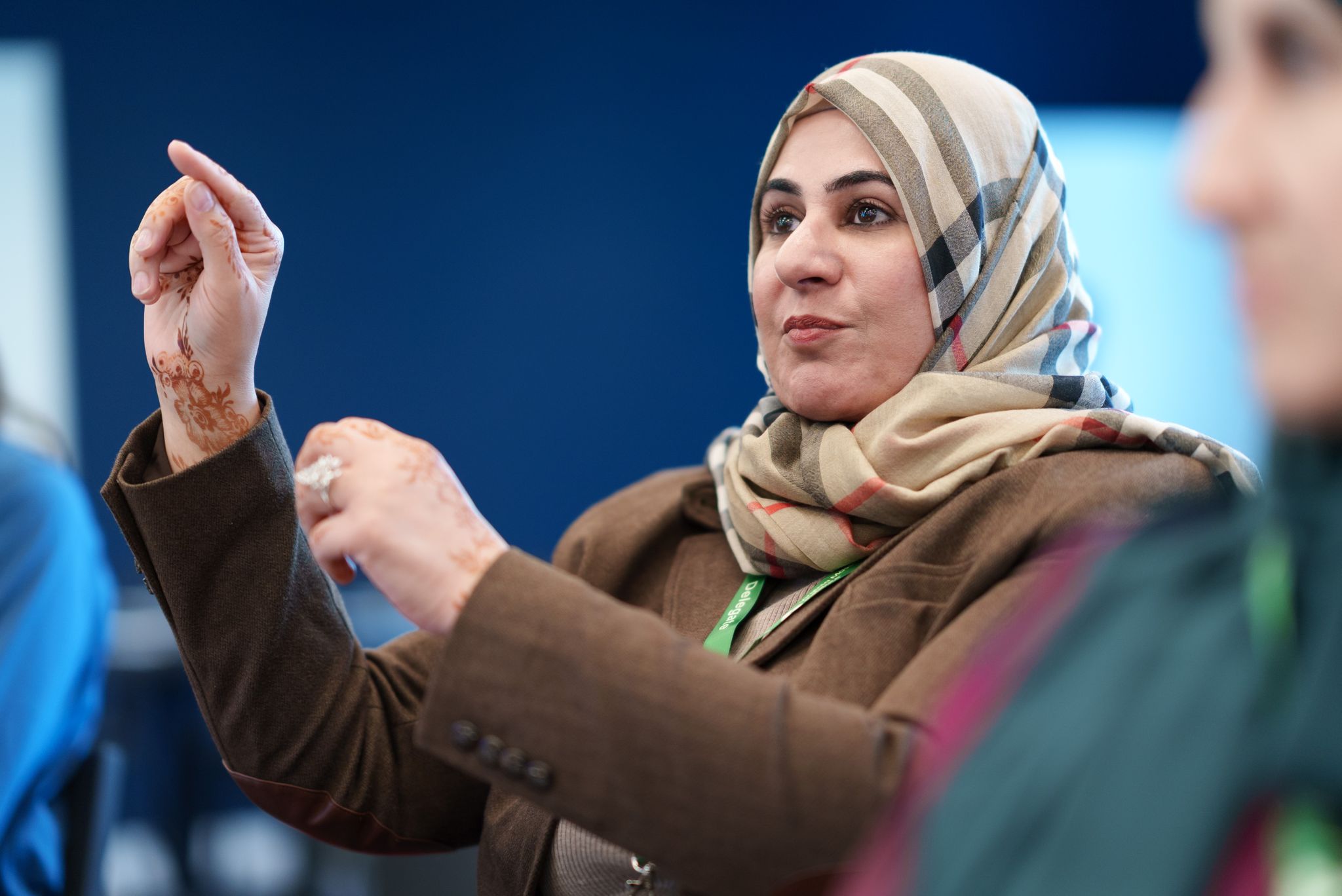 Lady with hair covered speaking at a conference