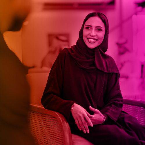 Arabic lady sitting down having a conversation