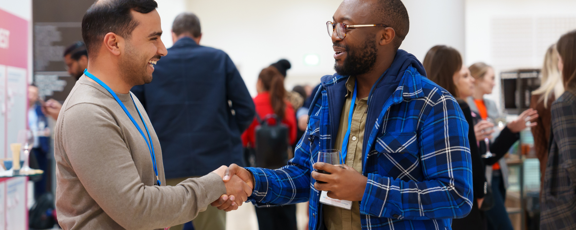 Two people shaking hands at a conference