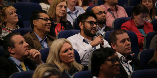 Man with microphone at conference