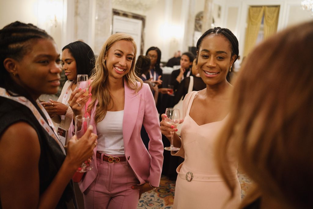 Two professional women smiling and networking