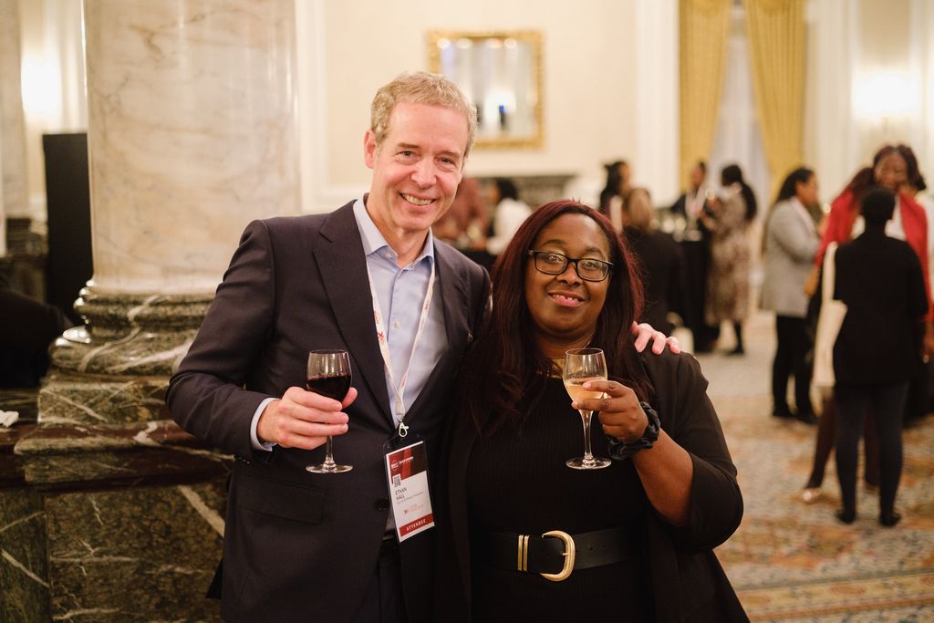 Man and woman professionals smiling at conference