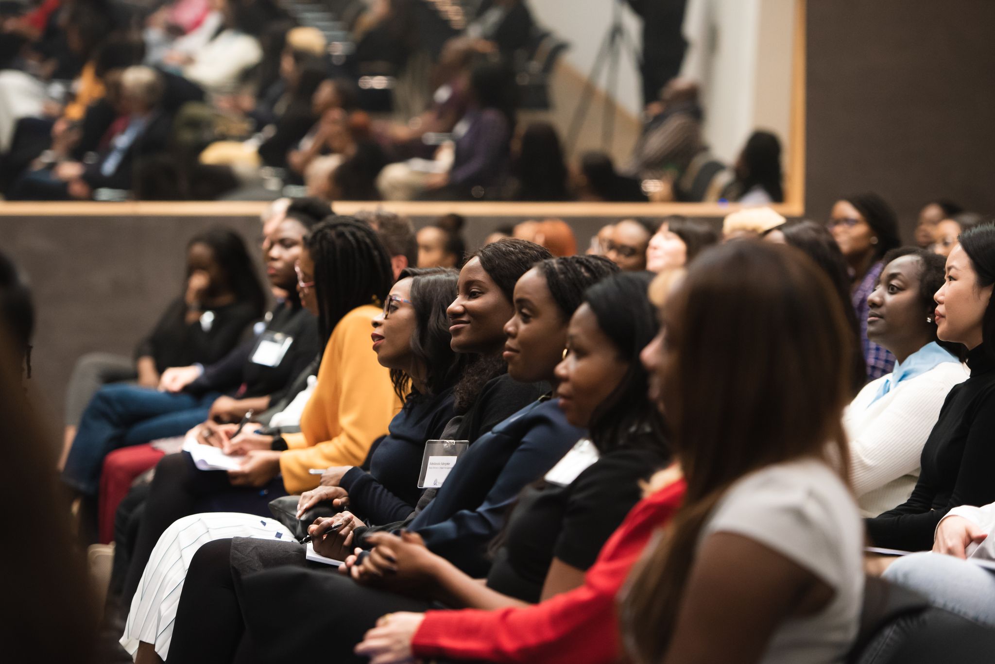 A photo of women in the audience at a conference 