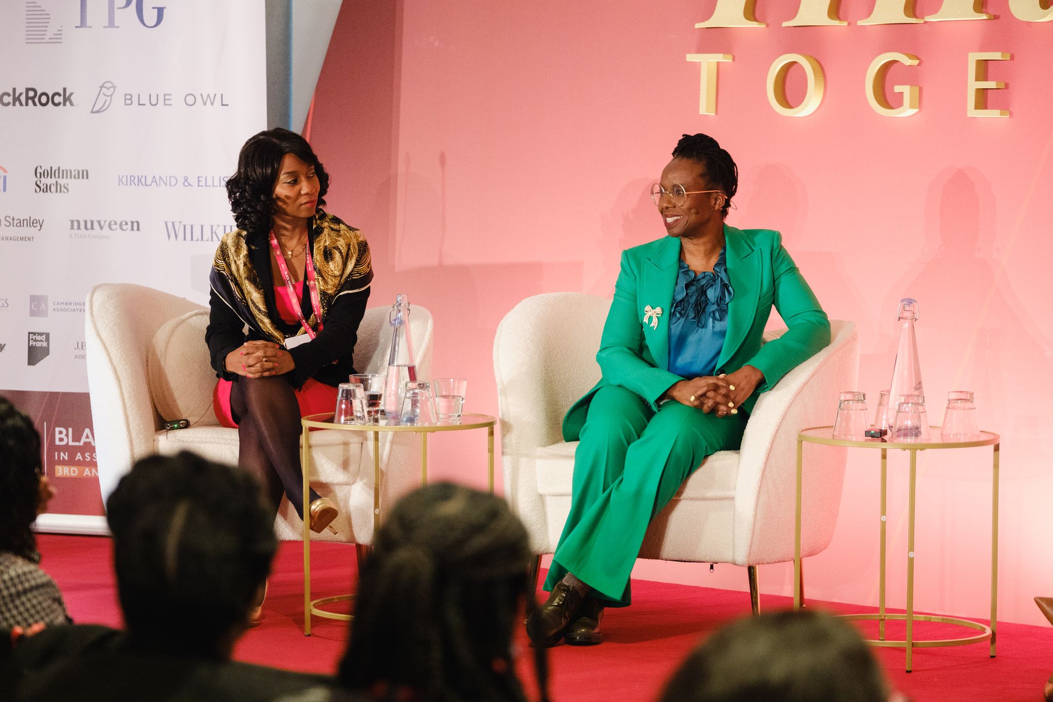 Two women on stage talking at the BWAM annual conference