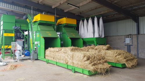Twin KME bale breakers feeding conventional baler