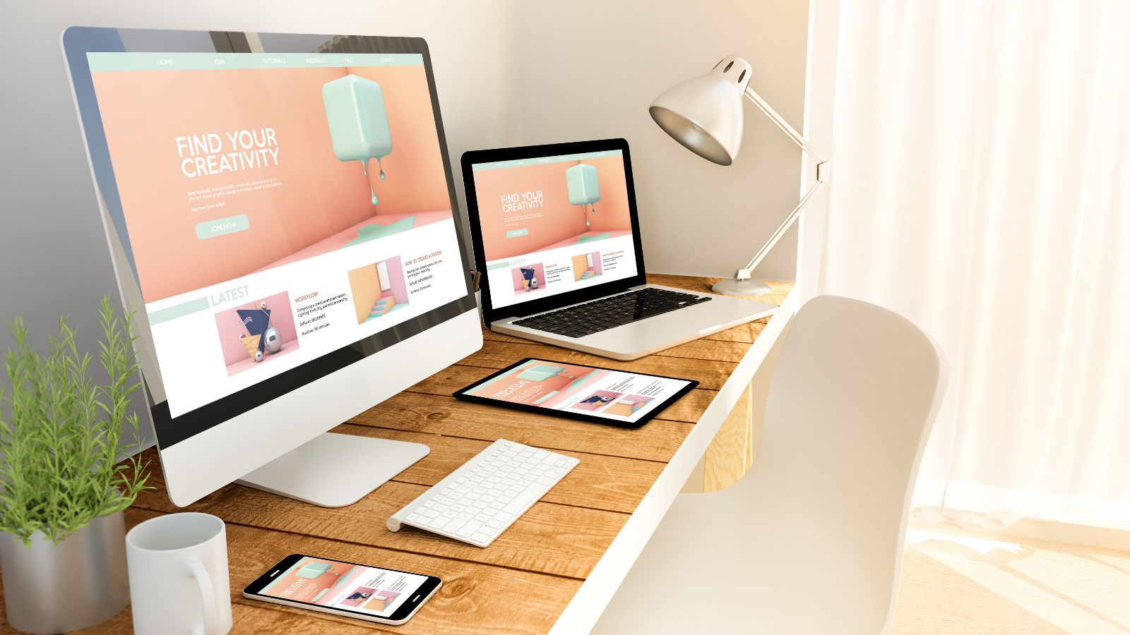 a desk with a pc, laptop, and smart phone depicting the same website