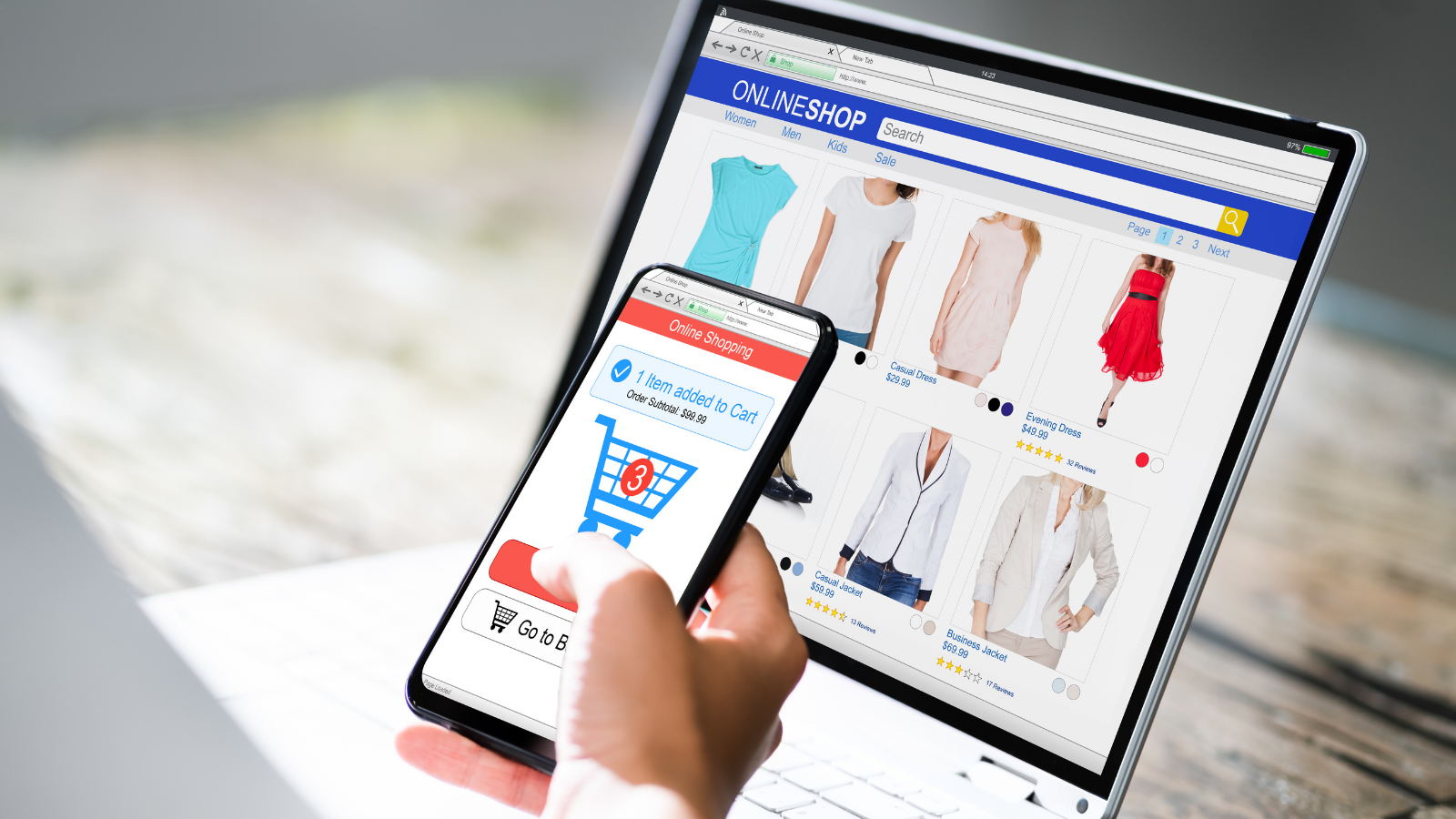 a stock image depicting e-commerce, a phone and laptop with graphs on the screen