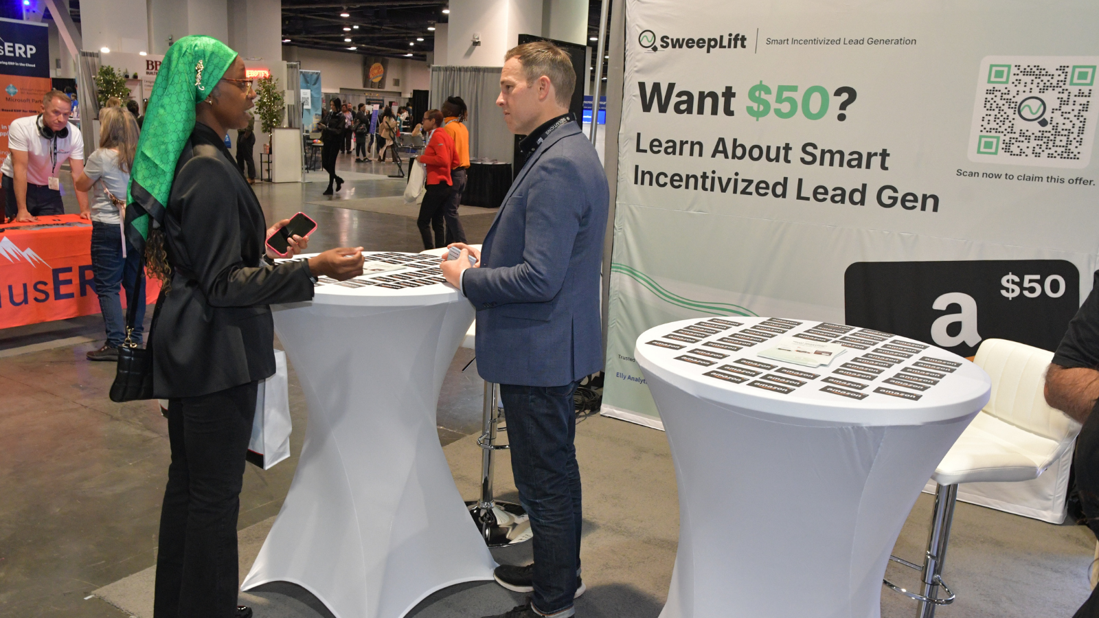 An image of an attendee and exhibitor talking at the B2B Marketing Expo