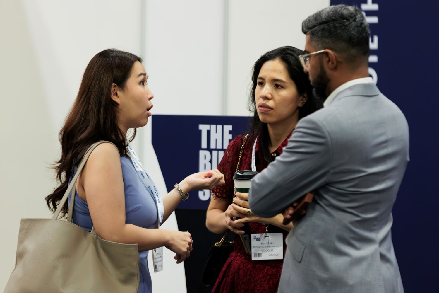 Professionals networking and discussing ideas at a business expo, exchanging insights during a conference in Singapore