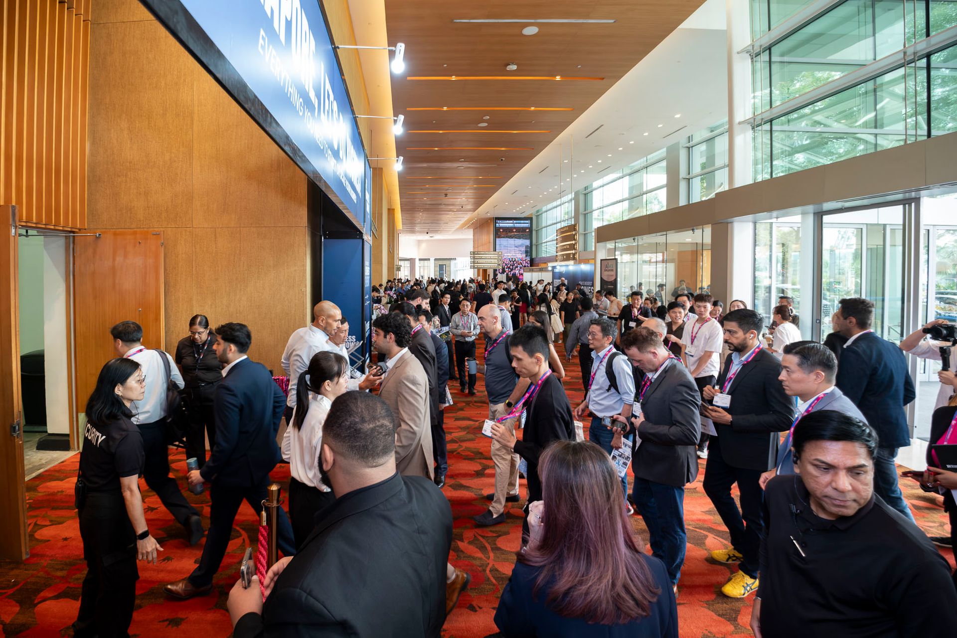 “Entrance to The Business Show Asia in Singapore, with attendees entering under a ‘Let’s Do Business’ banner”