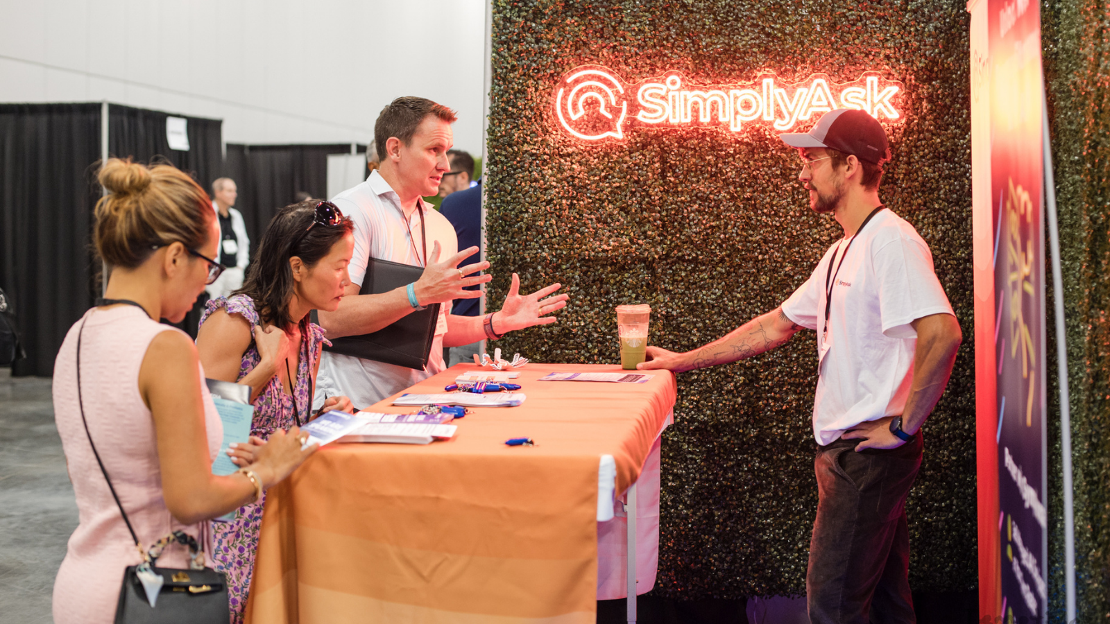 An image of two people talking to an exhibitor at the B2B Marketing Expo US