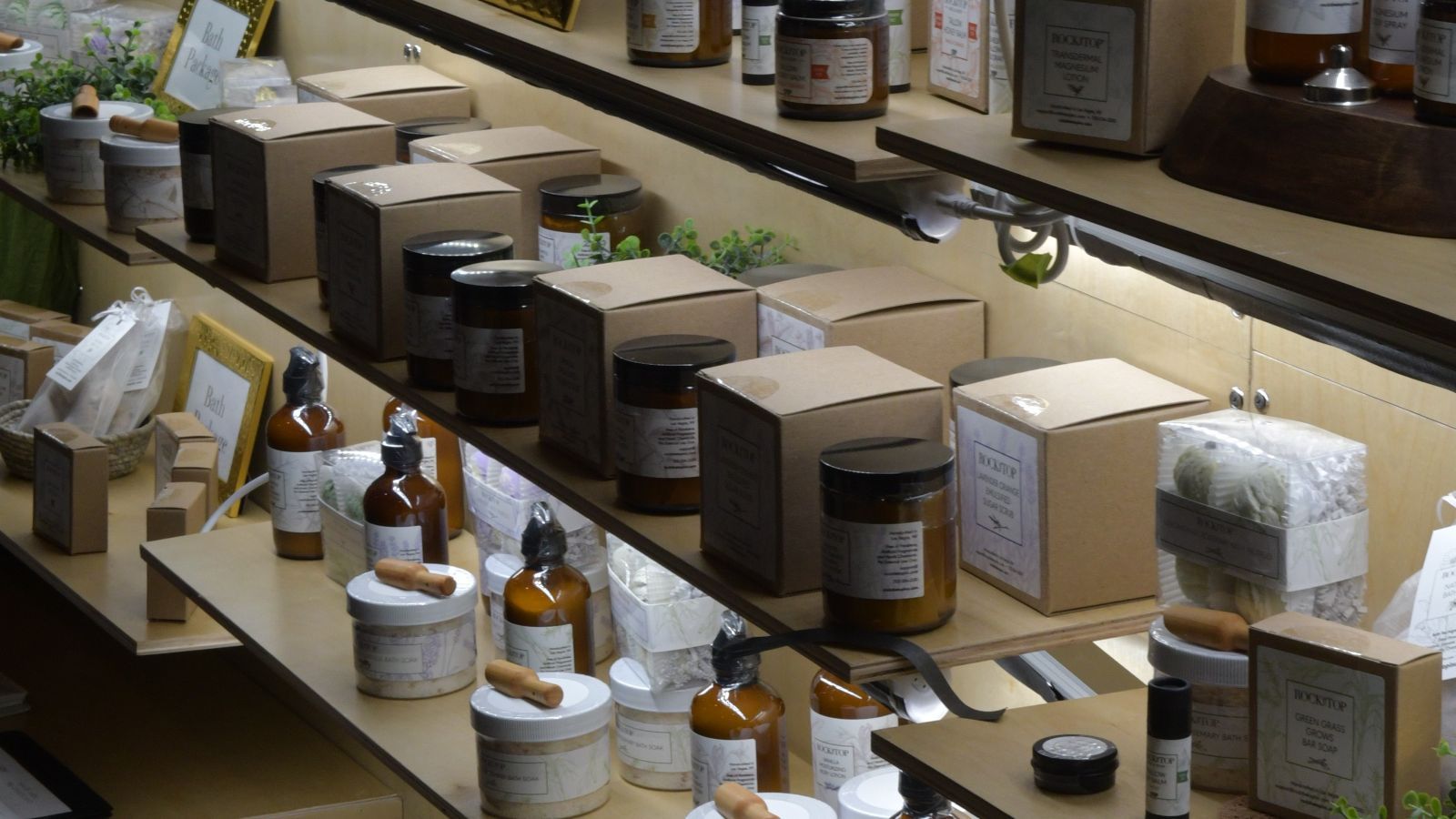 A table at a trade show full of merchandise for Jolt Strategies, the foreground contains tote bags
