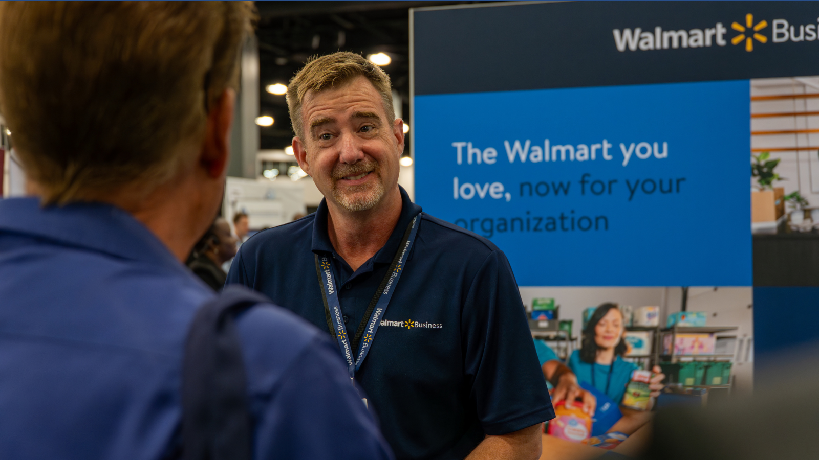 A man representing Walmart at The Business Show US, talking to an attendee