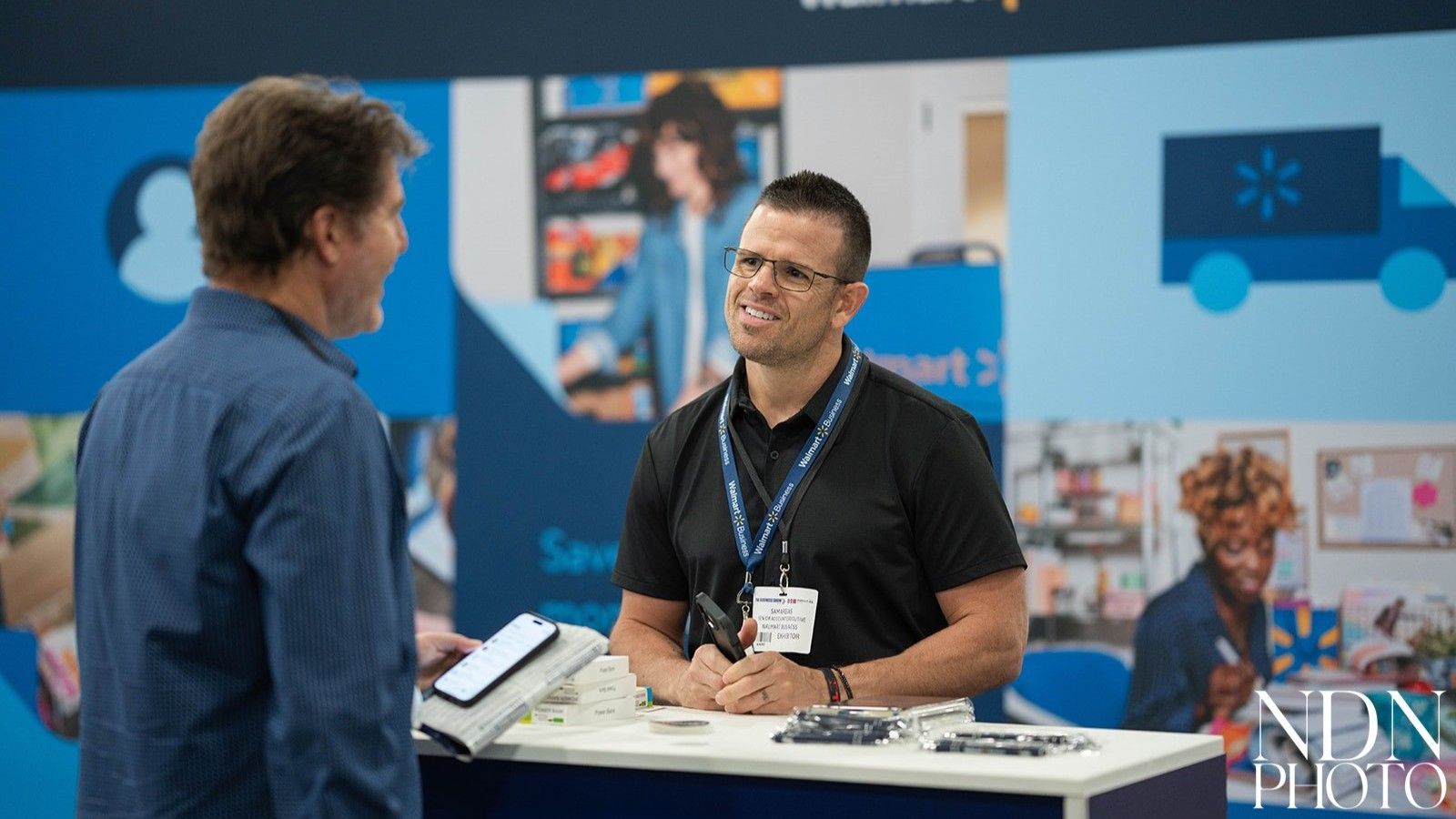 A representative from Walmart talking to an attendee at The Business Show Miami 2025