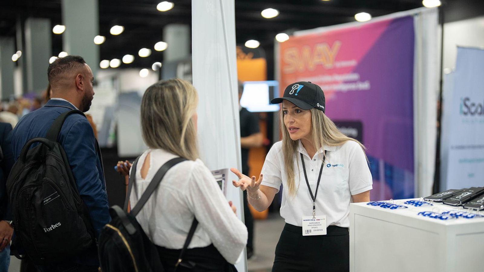 Business professionals in discussion at The Business Show Miami exhibition floor, connecting with exhibitors and exploring commercial solutions.