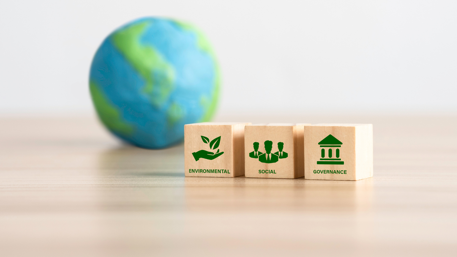 A picture of the ESG terms as building blocks, with the earth in the background