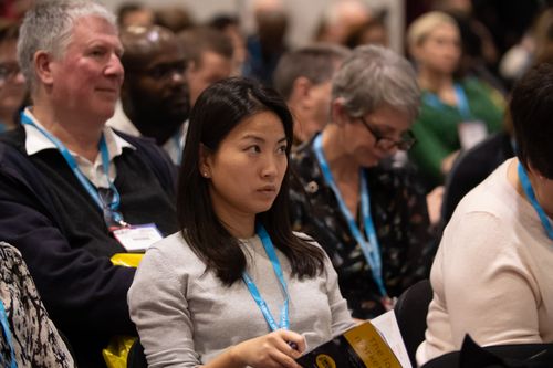 Women in Crowd Listens to Talk