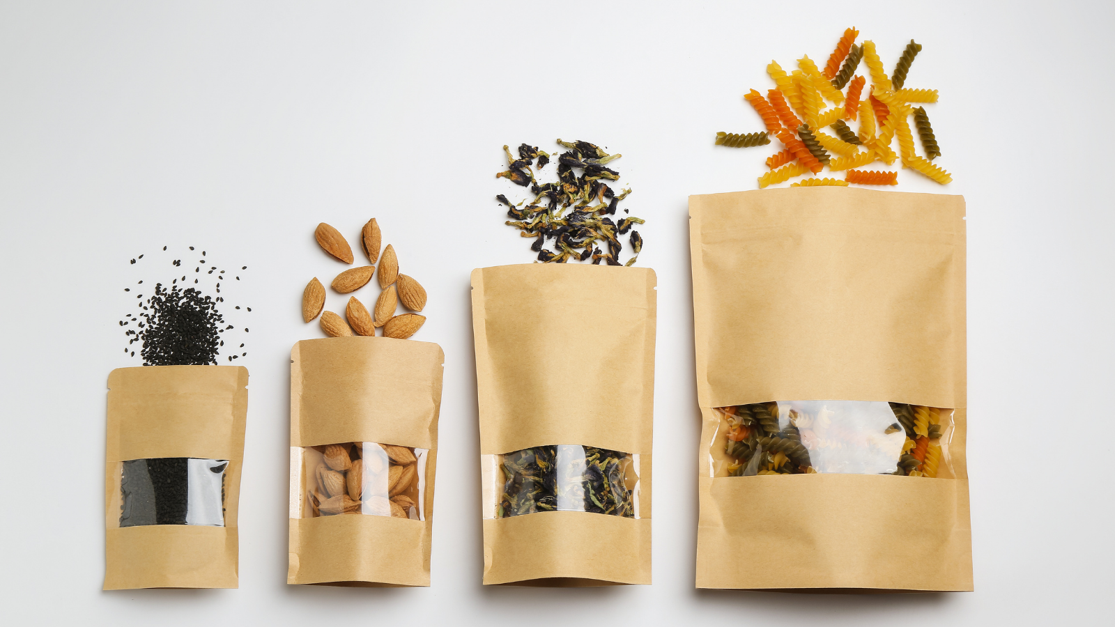 Private label food products in eco-friendly packaging including pasta, almonds, seeds, and loose tea displayed in kraft paper pouches