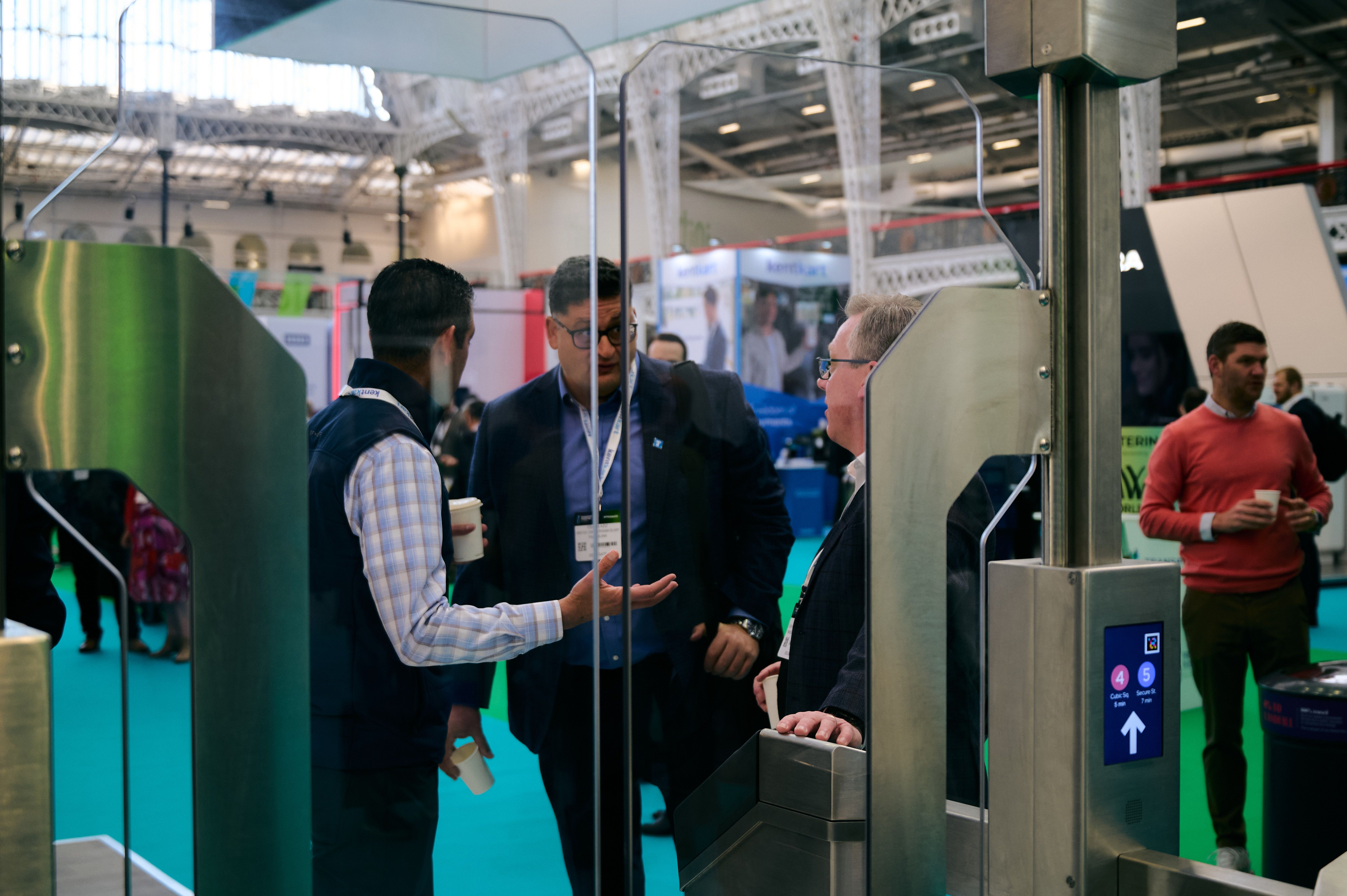An exhibitor showing a visitor their transit gates
