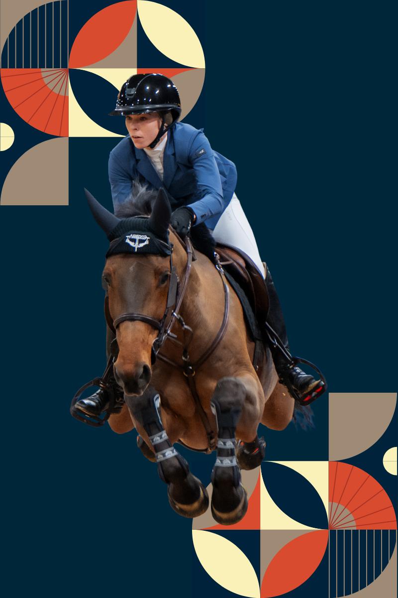 Female equestrian rider in a blue jacket and black helmet guiding a brown horse mid-jump during a competition. The horse is wearing ear covers and leg wraps, and both horse and rider appear focused and airborne, with no visible background.