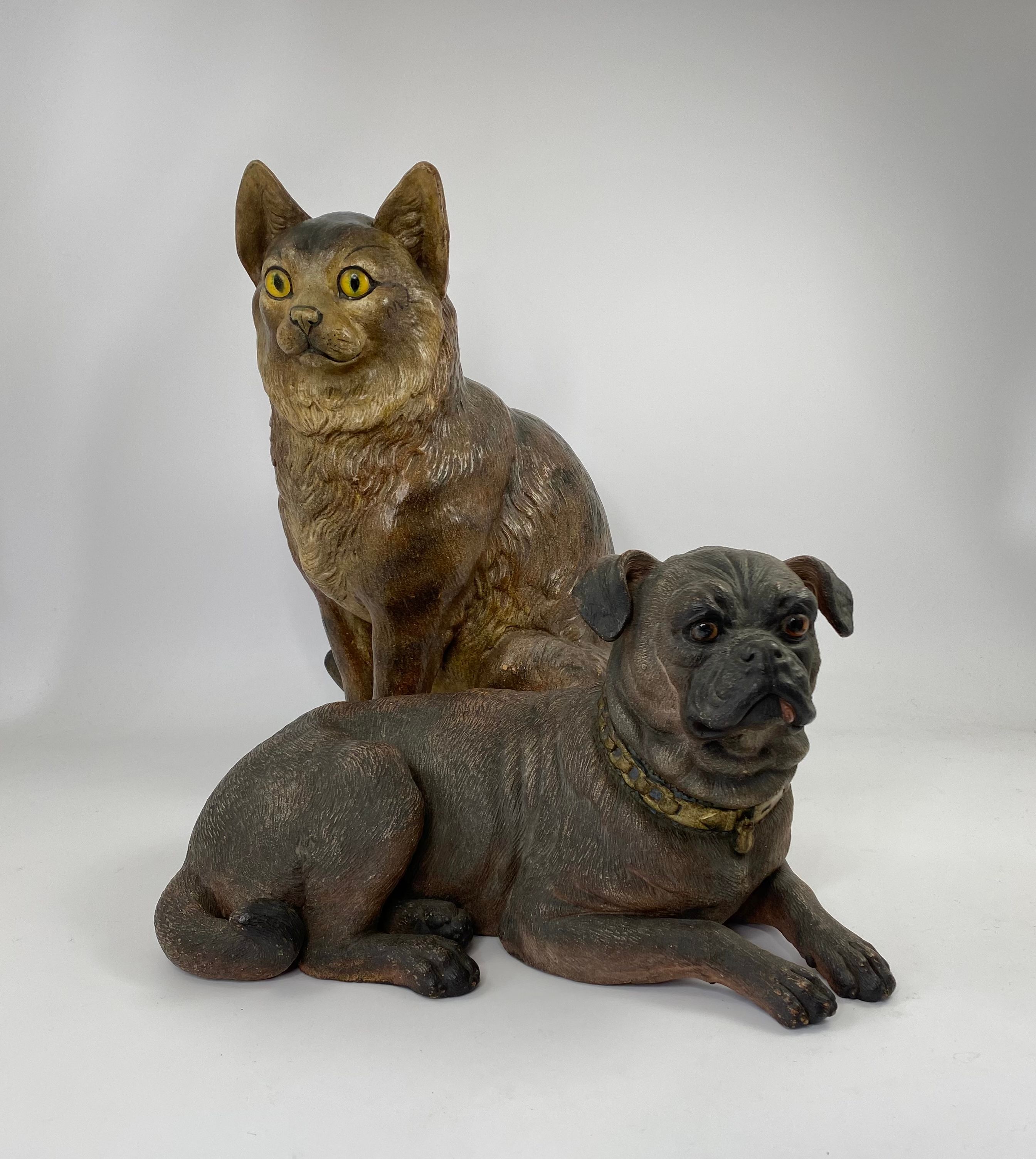 Austrian terracotta pug, and cat figures, c. 1890.