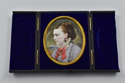 A cased portrait miniature of a lady painted in enamel on metal, signed to the back T/M 1875 for Thomas Herbert Maguire (1821-1895).