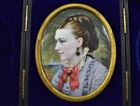 A cased portrait miniature of a lady painted in enamel on metal, signed to the back T/M 1875 for Thomas Herbert Maguire (1821-1895).