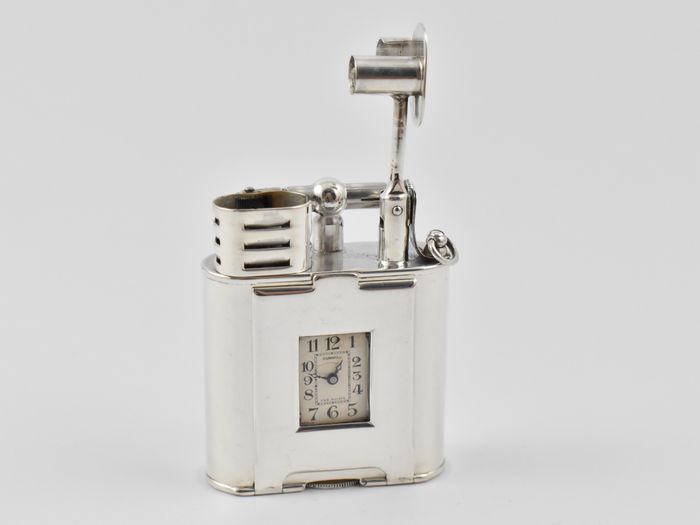 Art Deco sterling silver, single wheel Dunhill watch lighter. The watch signed ‘DUNHILL FAB. SUISSE’ and the case ‘ALFRED DUNHILL PARIS PAT. NO.143752’.