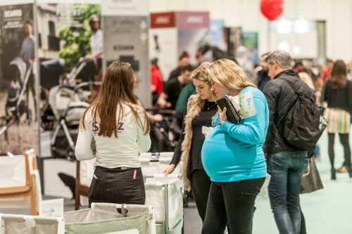 Pregnant women browsing baby products.